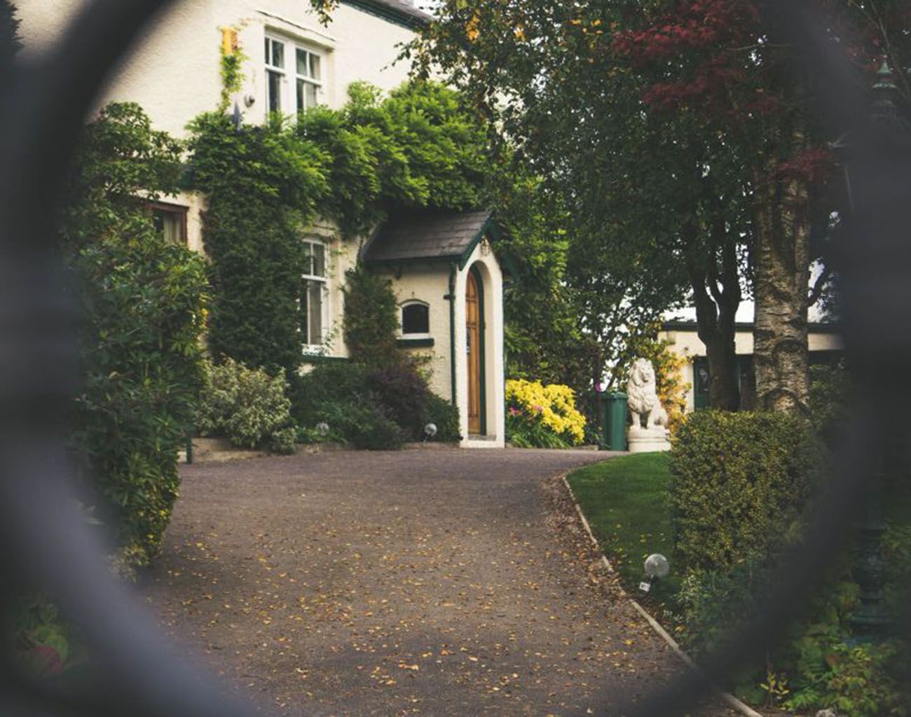 A private Texas estate home viewed down a tree-lined drive