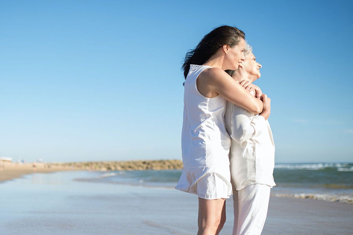A parent and child at the beach, representing guardianship and family protection