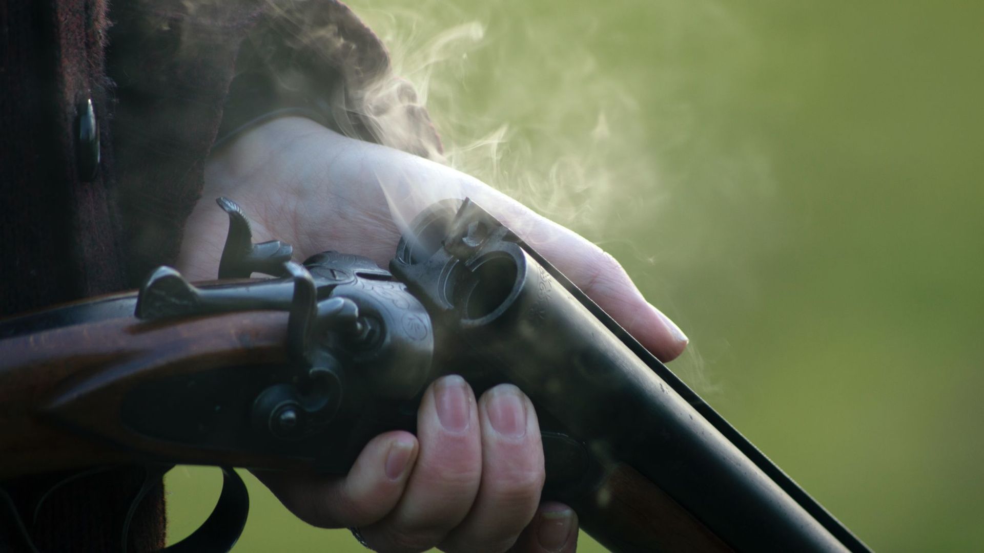 Hands holding a firearm, representing gun trust planning
